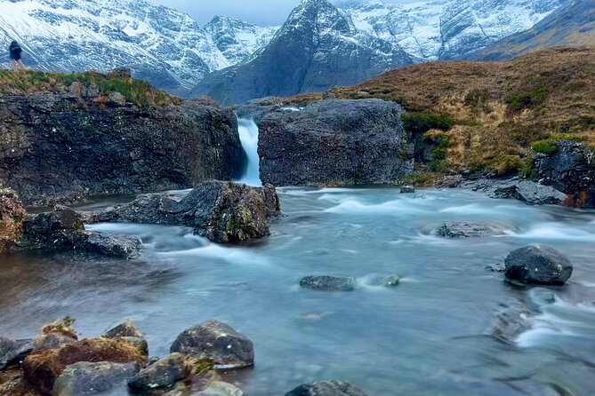 The landscape of the Isle of Skye is a captivating tapestry of dramatic cliffs, rolling moors, cascading waterfalls, and shimmering lochs, shrouded in mist and rich with rugged beauty.