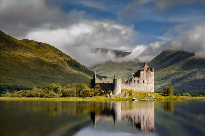Nestled against the rugged backdrop of the Scottish Highlands, the majestic castle stands in silent reflection upon the calm waters of the loch, its grandeur mirrored in the tranquil surface, creating a mesmerizing scene of timeless beauty.